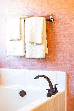 New modern bathtub, faucet and towels hanging abstract