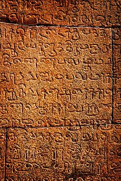 Ancient inscriptions on stone wall in Tamil language India