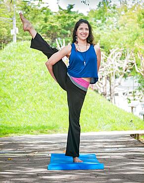 Girl doing yoga bird of paradise, a girl doing yoga outdoors, A woman doing balance yoga, person doing yoga Svarga Dvijasana