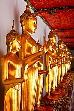 Standing golden Buddha statues close up. Wat Pho temple, Bangkok, Thailand, Asia