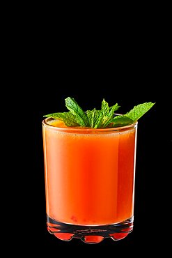 Hot red currant and orange winter drink with honey isolated on black