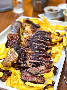 Sliced tomahawk steak with french fries Mallorca Spain