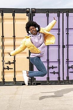 Portrait young woman with headphones jumping9