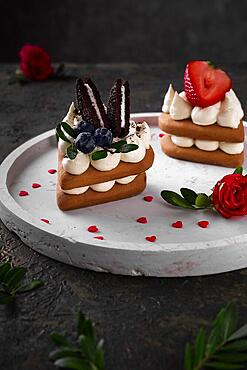 Sponge cakes, a heart-shaped cakes with cream and fruit. Dessert on Valentine's Day