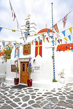 Cycladic Greek Orthodox Church decorated with flags, alleys of the old town Chora, Mykonos Town, Mykonos, Cyclades, Greece, Europe