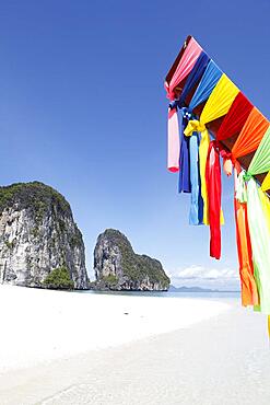 Karst rocks and white sandy beach, colourful cloths on longtail boat, Koh Lao Liang, Andaman Sea, Southern Thailand, Thailand, Asia