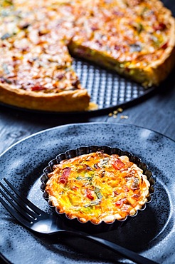 Quiche Lorraine - traditional French tart with pastry crust filled with bacon and leek