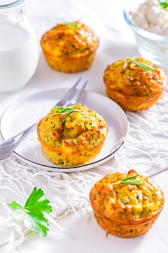 Delicious homemade zucchini muffins with feta cheese on white kitchen table