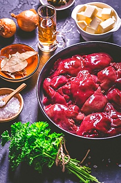 Raw chicken liver with cooking ingredients for liver pate, herbs and brandy