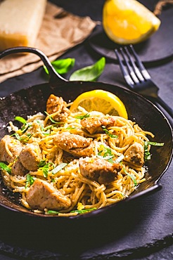 Lemon Chicken Pasta in cast iron pan with basil and Parmesan