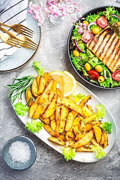 Potato wedges, oven roasted with freshly mixed salad and grilled cheese