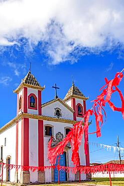 Small simple colonial-style chapel decorated with ribbons for a religious celebration in the small town of Lavras Novas, Ouro Preto district in Minas Gerais, Brasil