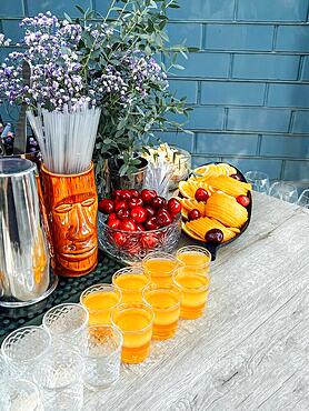 Glasses of cocktails on the bar. Glasses of sparkling wine with red alcohol. Preraring aperol spritz cocktail in outdoor summer bar