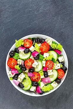 Greek salad with fresh tomatoes olives and feta cheese healthy eating food from above on slate with text free space in Stuttgart, Germany, Europe