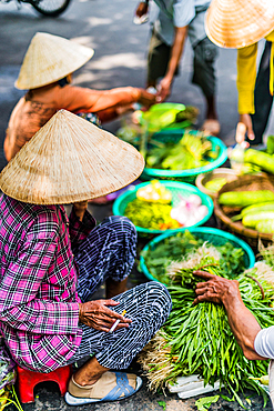 Women selling food on the street of Hoi An in Quang Nam Province, Vietnam, Asia