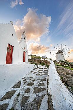 White Cycladic Greek Orthodox Twin Churches of Agios Antonios and Agios Nikolaos with Bonis Windmill at Sunrise, Mykonos Town, Mykonos, Cyclades, Greece, Europe