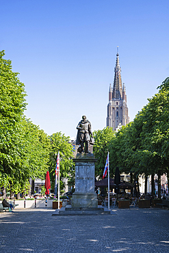 Simon Steviplein with the statue of the Flemish mathematician and physicist Simon Stevin, behind it the Church of Our Lady, Bruges, Belgium, Europe