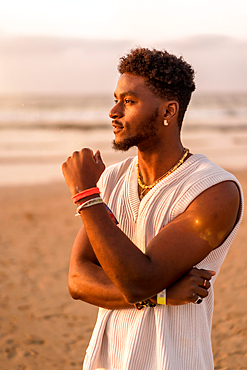 Portrait of black ethnicity model enjoying summer vacation by the sea basking in the sun