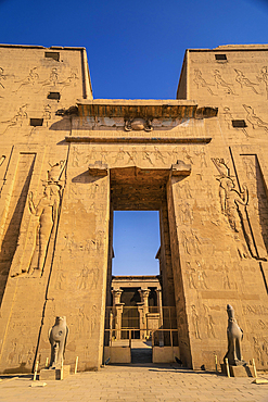 Facade with drawing of pharaohs of the Temple of Edfu in the city of Edfu, Egypt. On the bank of the Nile river, geco-Roman construction, temple dedicated to Huros