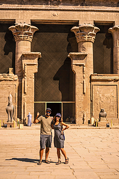 A tourist couple leaving the Edfu Temple near the Nile River in Aswan. Egypt, return of tourism in the coronavirus pandemic after 6 months stopped