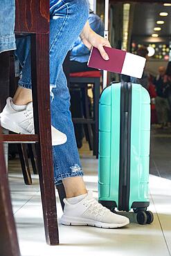 Side view woman sitting airport