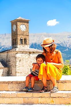 Mother and son having fun at the Clock Tower in the Ottoman Castle Fortress of Gjirokaster or Gjirokastra. Albanian