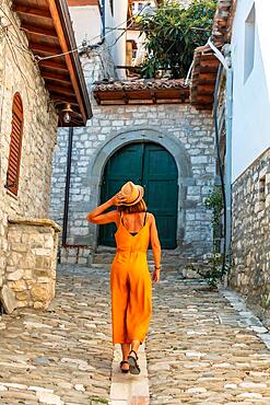 A tourist woman walking through the city of Berat in Albania, the city of a thousand windows