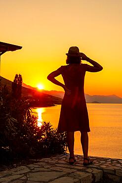 Silhouette of a woman at sunset at Shkoder lake in Shiroka municipality, summer vacation. Albania