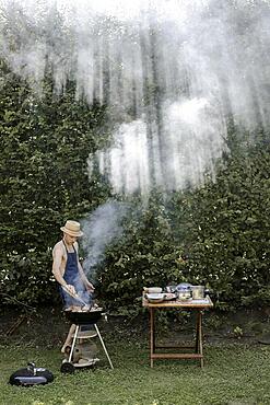 Man barbecuing in the garden