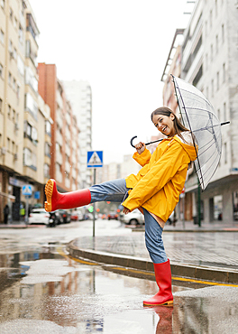 Woman with umbrella standing rain front view