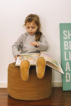 Cute girl reading pouf