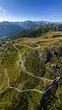 Assietta ridge road, aerial view at Monte Genevris, pass summit with summit cross, French-Italian Alps in the back, Sauze d'Oulx, Sestriere, Piedmont, Italy, Europe