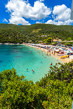 View of the beach in summer crowded with bather people at Paralia Mikros Gialos in Lefkada. Greece