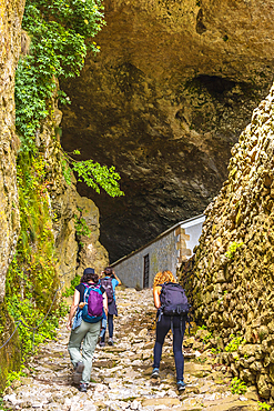 Friends arriving at the cave of San Adrian. Mount Aizkorri 1523 meters, the highest in Guipuzcoa. Basque Country. Ascent through San Adrian and return through the Oltza fields