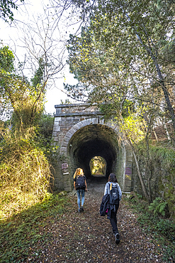 Deba, Gipuzkoa Spain, January 26, 2020: Two young men in a tunnel on the coast between Deba and Zumaia