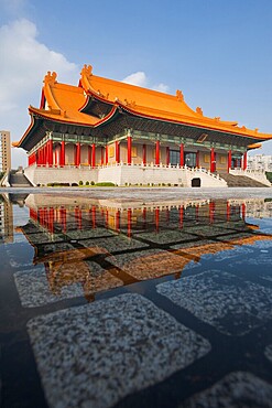 Taipei National Concert Hall beautifully reflected in a puddle of rainwater