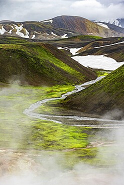 Colourful volcanic landscape with hills and snow, volcanic steaming hot springs, Laugavegur trekking trail, Landmannalaugar, Fjallabak Nature Reserve, Icelandic Highlands, Suðurland, Iceland, Europe