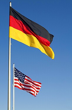 Flags of Germany and United States of America in front of blue sky