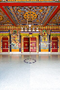 The beautifully decorated doors and ceiling at the entrance to the Rumtek monastery, home of the Karma Kagyu line of Tibetan buddhism, in Gangtok, Sikkim, India. Vertical