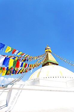 Prayer flags on white second level of Boudhanath Stupa in Kathmandu, Nepal on October 23, 2013. Vertical