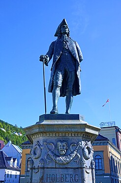 Ludvig Holberg statue on a pedestal in front of historic buildings on a sunny day, Bergen, Vestland, Norway, Europe