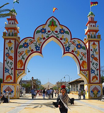 Colourful gate with floral patterns, people in the background, festive atmosphere, Feria de la Manzanilla, Feria de Sanlúcar, Sanlúcar de Barrameda, Sanlucar, Cádiz, Cadiz, Andalusia, Spain, Europe