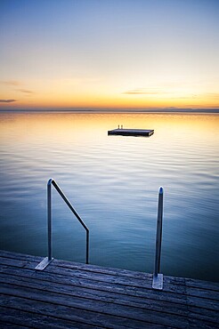 Sunset at Weiden on the lake with ladder and swimming island