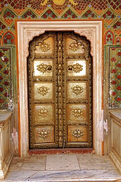 City Palace Jaipur, Rajasthan, North India, India, Asia, Golden decorated door with floral patterns in architectural frame