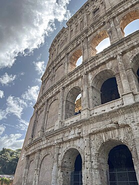 Architectural details of the Colosseum with clouds in the background, Rome, Italy