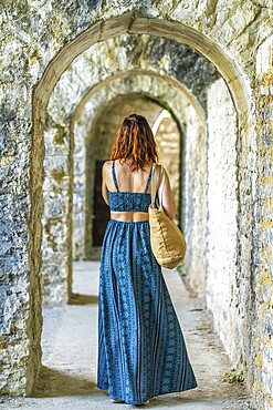 Tourist admiring the arches of sauveterre de bearn in france, enjoying a summer vacation exploring historical landmarks