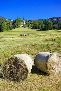 Church and hay bales, Vigo di Fassa, Fassa Valley, Trento Province, Trentino-Alto Adige/South Tyrol, Italian Dolomites, Italy, Europe