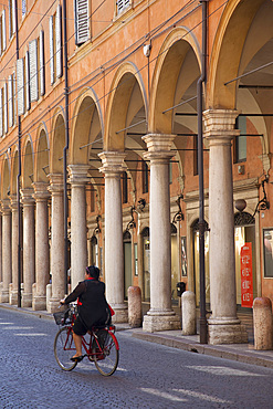 Arcade arches and cyclist, Modena, Emilia Romagna, Italy, Europe