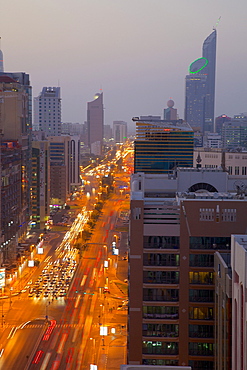 City skyline and Rashid Bin Saeed Al Maktoum Street at dusk, Abu Dhabi, United Arab Emirates, Middle East
