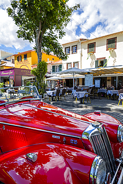 View of red vintage MG car in front of traditional Al Fresco restaurant in old town, Funchal, Madeira, Portugal, Europe
